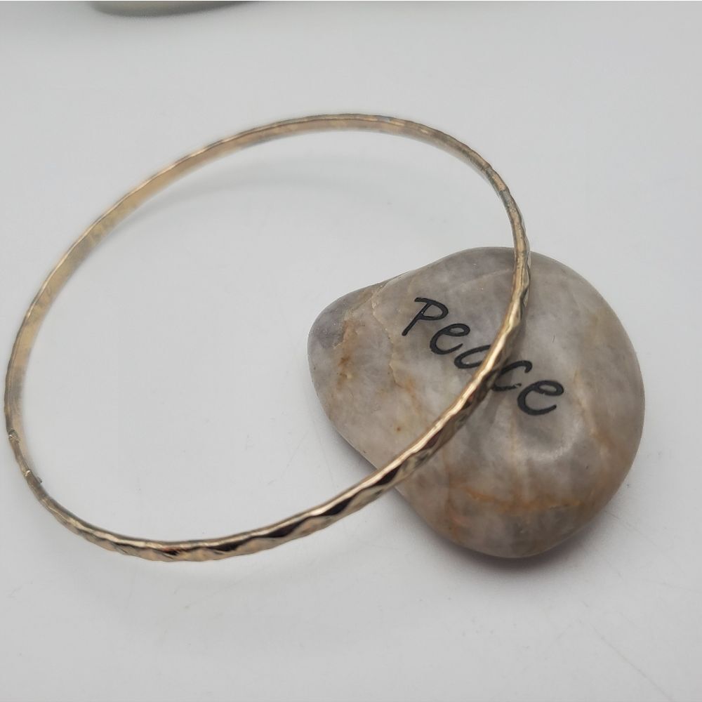 Celtic gold toned round slender bracelet
